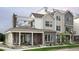 Two-story modern home with brick exterior, covered porch, and rooftop deck at 888 S Valentia St # 106, Denver, CO 80247