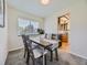 Dining room with a wooden table and chairs, view into kitchen at 7993 S Jay Dr, Littleton, CO 80128