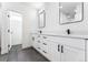 Modern bathroom with white double vanity, black fixtures, and a walk-in shower at 1420 Pierce St, Lakewood, CO 80214