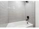 Clean bathroom with bathtub and gray tile at 1420 Pierce St, Lakewood, CO 80214