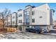 Modern three-story townhome building with parking and fenced yard at 1420 Pierce St, Lakewood, CO 80214