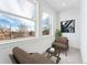 Bright sitting room with large windows and city views, featuring two comfy armchairs at 1420 Pierce St, Lakewood, CO 80214