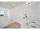Modern wet bar with sink and white cabinets at 1420 Pierce St, Lakewood, CO 80214