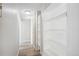 Bright hallway with built-in shelving and light wood laminate flooring at 799 Dahlia St # 501, Denver, CO 80220