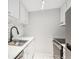 Clean and efficient kitchen with white cabinets at 799 Dahlia St # 501, Denver, CO 80220