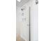 Shower with white tiled walls and multiple shower heads at 799 Dahlia St # 501, Denver, CO 80220