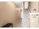 Bright entryway with staircase, wood floors, and storage bench at 8626 Gold Peak Dr # B, Highlands Ranch, CO 80130