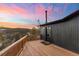 Spacious deck with mountain views and sunset in background at 11725 Tomahawk Trl, Conifer, CO 80433