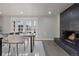 Bright dining area with modern table and chairs, and a fireplace with a view at 11725 Tomahawk Trl, Conifer, CO 80433