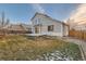 House exterior and backyard with deck and grass at 303 Tumbleweed Dr, Brighton, CO 80601