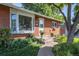 Front entrance of a brick ranch home with landscaping and steps at 3661 W Greenwood Pl, Denver, CO 80236