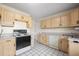 Kitchen boasts light wood cabinets and ample counter space at 3661 W Greenwood Pl, Denver, CO 80236