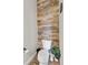 Bathroom with toilet and rustic wood feature wall at 6001 S County Road 161, Strasburg, CO 80136
