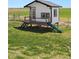 Charming playhouse with slide in the backyard at 6001 S County Road 161, Strasburg, CO 80136