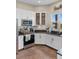 L-shaped kitchen with stainless steel appliances and tiled floor at 6001 S County Road 161, Strasburg, CO 80136