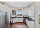 Spacious kitchen with stainless steel appliances and granite countertops at 6001 S County Road 161, Strasburg, CO 80136