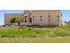 Tan stucco home with a large yard and beautiful landscaping at 6001 S County Road 161, Strasburg, CO 80136
