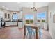 Kitchen with white cabinets, tile floor, and views of the backyard at 6001 S County Road 161, Strasburg, CO 80136
