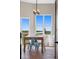 Bright dining area with wooden table and light blue chairs at 6001 S County Road 161, Strasburg, CO 80136