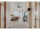 Main bedroom with fireplace and access to balcony at 6001 S County Road 161, Strasburg, CO 80136