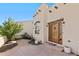 Elegant entryway with a custom wooden door and stone patio at 6001 S County Road 161, Strasburg, CO 80136