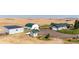 Aerial view of a ranch home with detached buildings and large yard at 6751 S County Road 129, Bennett, CO 80102