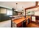 Basement wet bar with brick accents and wood cabinetry, offering a convenient space at 6751 S County Road 129, Bennett, CO 80102