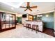 Basement bar with brick facade, two stools, and a view into the game room at 6751 S County Road 129, Bennett, CO 80102