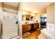 Elegant bathroom with double vanity, soaking tub, and separate shower at 6751 S County Road 129, Bennett, CO 80102