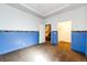 Basement bedroom with blue walls and a walk-in closet at 6751 S County Road 129, Bennett, CO 80102