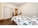 Charming basement bedroom with floral bedding and a spacious closet at 6751 S County Road 129, Bennett, CO 80102