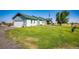 Ranch style home with attached garage and expansive green lawn at 6751 S County Road 129, Bennett, CO 80102