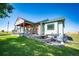 Brick and siding ranch home with a covered porch and well-manicured lawn at 6751 S County Road 129, Bennett, CO 80102