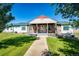 Ranch style home with brick and siding, covered porch, and landscaped yard at 6751 S County Road 129, Bennett, CO 80102