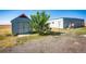 Property features a shed and a mobile home with a deck at 6751 S County Road 129, Bennett, CO 80102