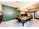 Basement game room with pool table, wet bar, and ample space for entertainment at 6751 S County Road 129, Bennett, CO 80102