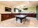 Basement game room featuring a pool table, wet bar, and built-in shelving at 6751 S County Road 129, Bennett, CO 80102