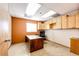 Simple office space with wood desk, cabinets, and a window at 6751 S County Road 129, Bennett, CO 80102