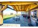 Large covered patio, outdoor seating, and grill at 6751 S County Road 129, Bennett, CO 80102
