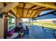 Covered patio with seating area and built-in grill at 6751 S County Road 129, Bennett, CO 80102