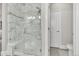 Bathroom with a walk-in shower and marble tile at 7215 S Robertsdale Way, Aurora, CO 80016