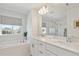 Modern bathroom with double vanity, soaking tub, and walk-in shower at 17428 Hop Clover Ave, Parker, CO 80134