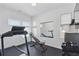 Home gym with treadmill, weights, and a mirror at 17428 Hop Clover Ave, Parker, CO 80134