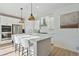 Modern kitchen with white cabinets, stainless steel appliances, and an island with seating at 17428 Hop Clover Ave, Parker, CO 80134