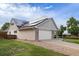 Home with solar panels, attached garage, and landscaped yard at 7171 S Teller Ct, Littleton, CO 80128