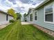 Backyard view showing a house with a grassy area and patio at 6165 Needlegrass Grn # 313, Frederick, CO 80530