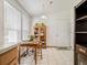 Kitchen nook with wood table and chairs, and built-in shelving at 6165 Needlegrass Grn # 313, Frederick, CO 80530