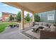 Covered patio with comfortable seating overlooking the backyard at 20052 W 95Th Pl, Arvada, CO 80007