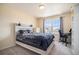 Bright bedroom with a large window, plush bedding, and built-in shelving at 20052 W 95Th Pl, Arvada, CO 80007