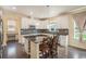 Eat-in kitchen with an island, granite countertops, and white cabinetry at 20052 W 95Th Pl, Arvada, CO 80007